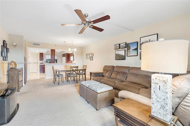 living room with light carpet, a textured ceiling, and ceiling fan