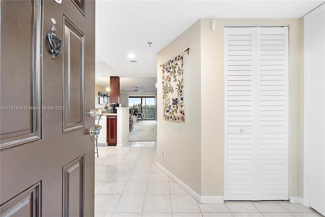 hall featuring light tile patterned flooring