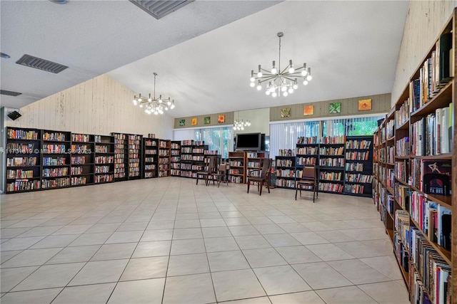 interior space featuring light tile patterned flooring, vaulted ceiling, and a chandelier