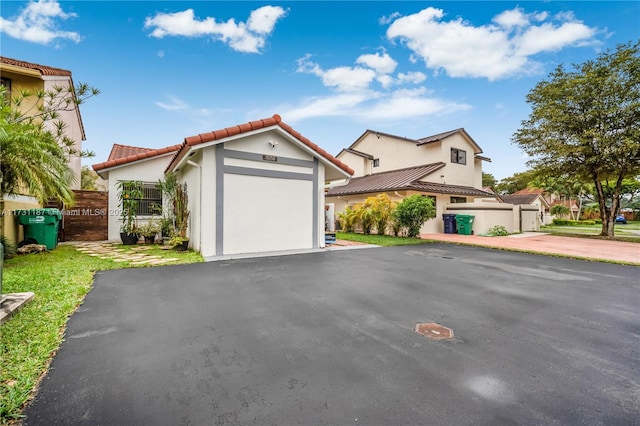 mediterranean / spanish-style house with a garage