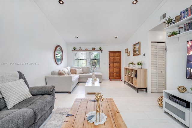 living room featuring lofted ceiling