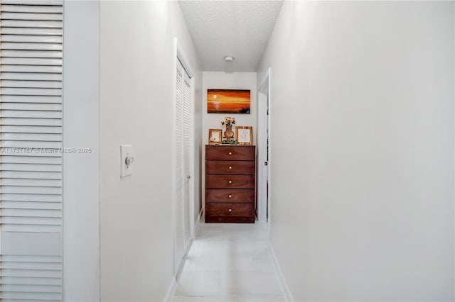 corridor with a textured ceiling