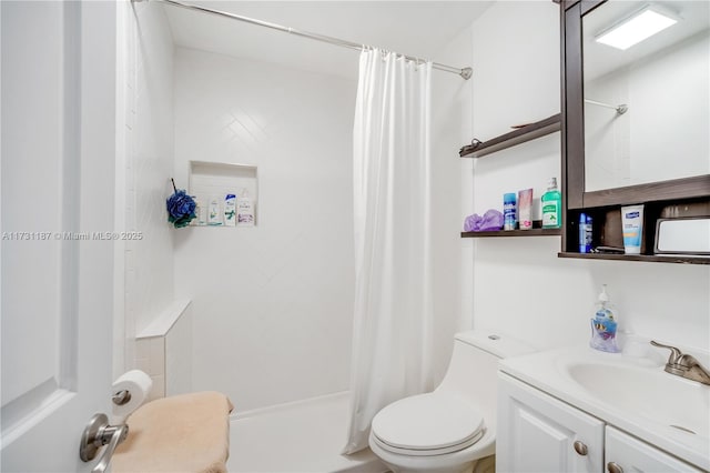 bathroom with vanity, a shower with shower curtain, and toilet