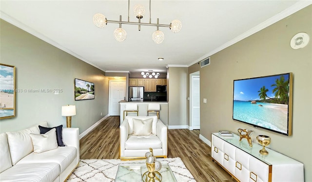 living room with crown molding and light hardwood / wood-style flooring