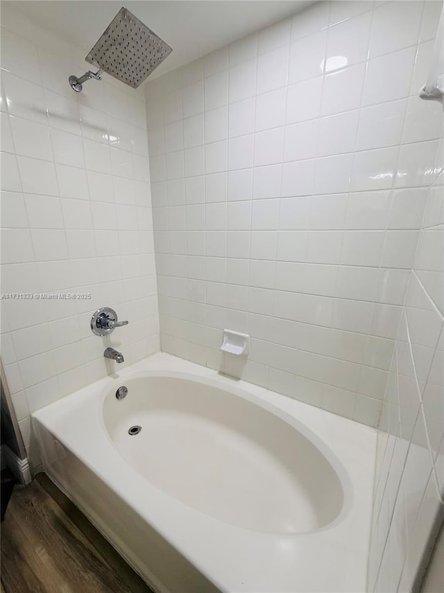 bathroom featuring hardwood / wood-style flooring and shower / bathtub combination