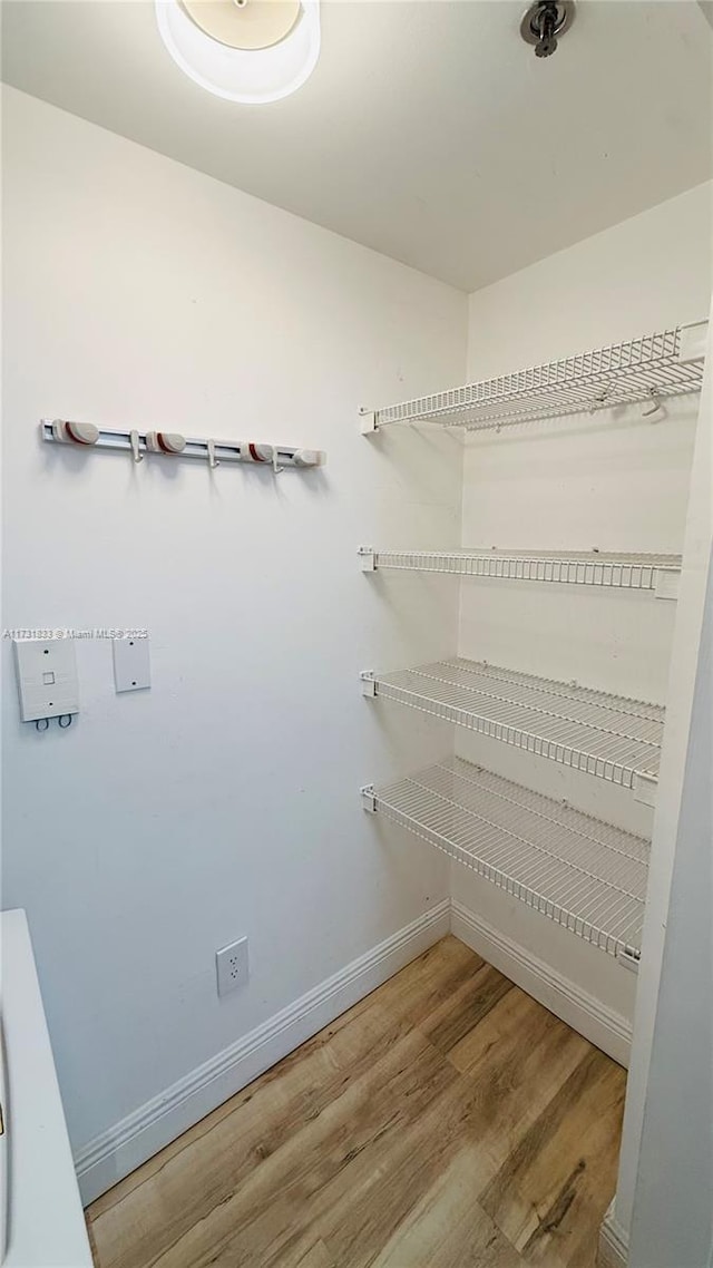 walk in closet featuring hardwood / wood-style floors