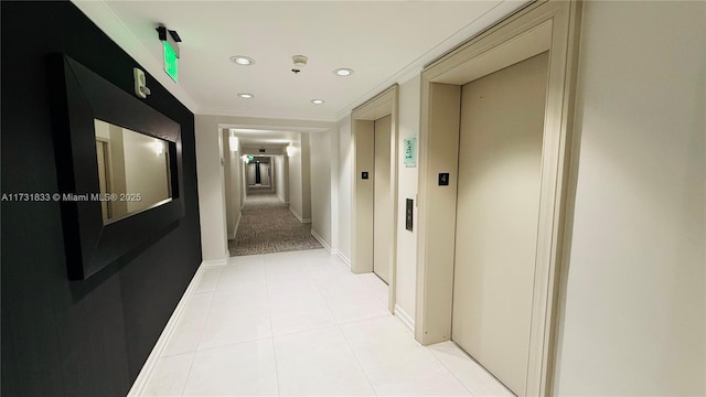 corridor featuring light tile patterned flooring, elevator, and ornamental molding