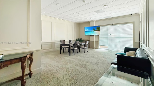 carpeted living room with crown molding