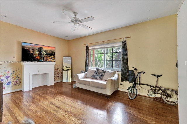 living room featuring hardwood / wood-style flooring and ceiling fan