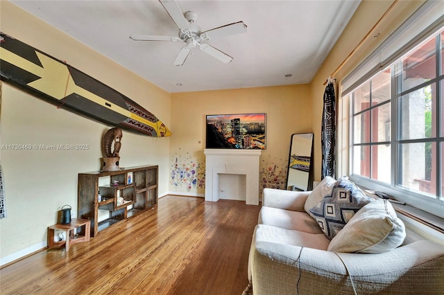 living room featuring hardwood / wood-style flooring, plenty of natural light, and ceiling fan