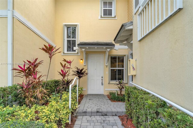 doorway to property with stucco siding