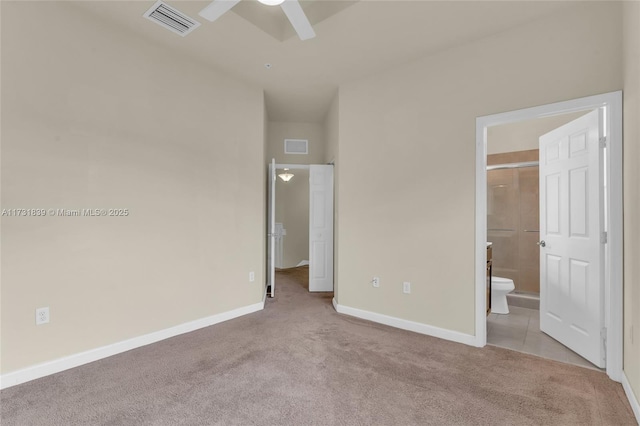 unfurnished bedroom with connected bathroom, light colored carpet, a ceiling fan, baseboards, and visible vents