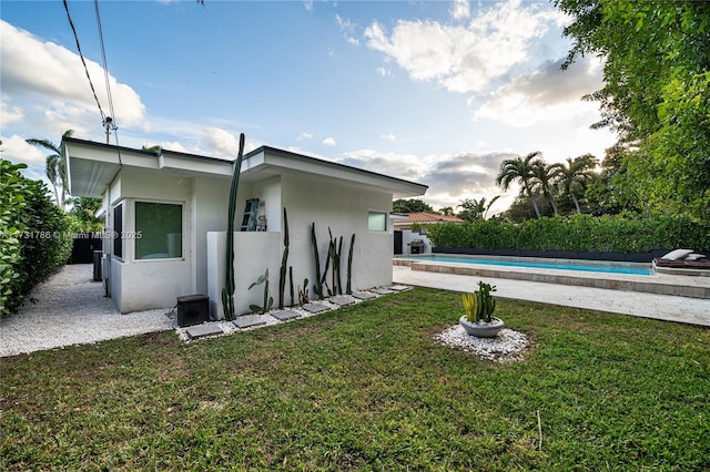 exterior space featuring a fenced in pool and a yard