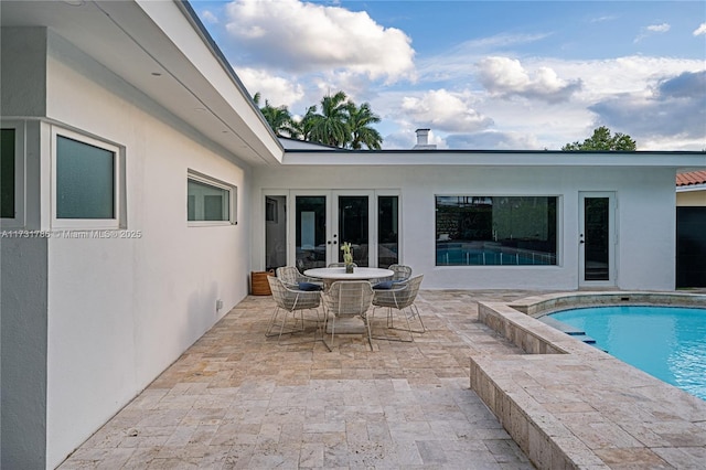 view of pool featuring french doors and a patio area