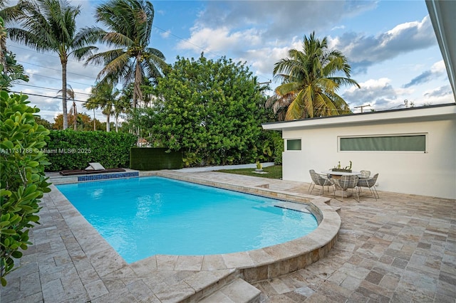 view of swimming pool with a patio area and an in ground hot tub