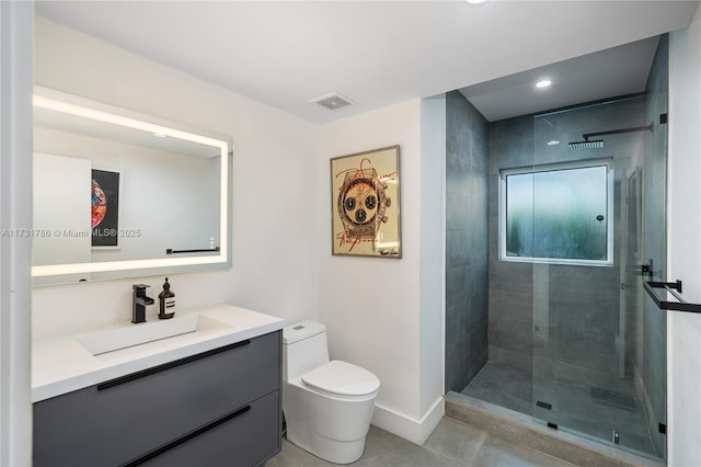 bathroom featuring vanity, toilet, and a tile shower