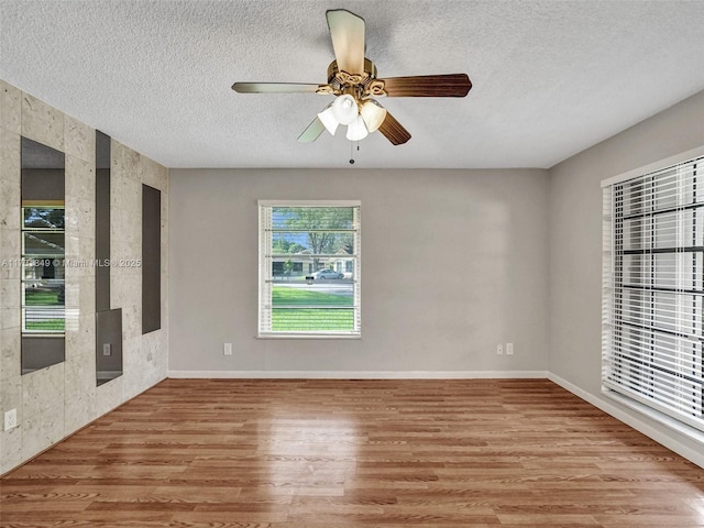 spare room featuring ceiling fan, a textured ceiling, and light hardwood / wood-style floors