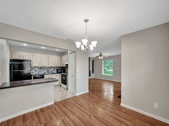 kitchen with backsplash, hanging light fixtures, black appliances, white cabinets, and light wood-type flooring