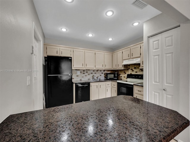 kitchen featuring tasteful backsplash, kitchen peninsula, cream cabinets, and black appliances