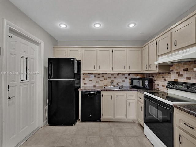 kitchen featuring cream cabinets, decorative backsplash, black appliances, and dark stone counters