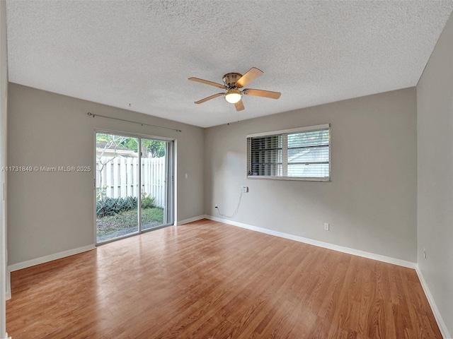 spare room with ceiling fan, light hardwood / wood-style floors, and a textured ceiling