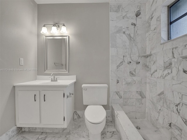 bathroom featuring vanity, toilet, and tiled shower