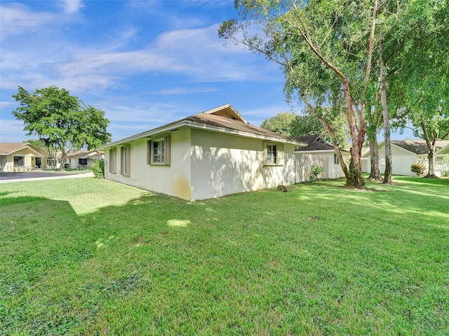 view of side of property with a lawn