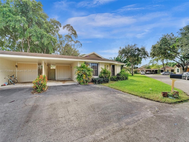 single story home with a front lawn and a carport