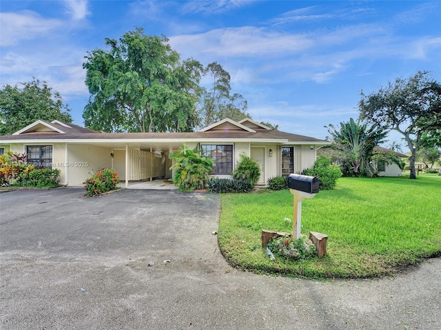 ranch-style house featuring a front lawn and a carport