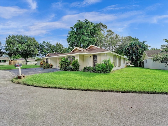 ranch-style house with a front lawn