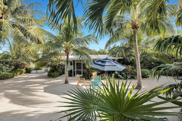 view of front of house with a sunroom and a patio area