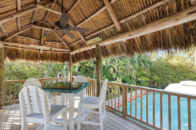 wooden deck with a gazebo and ceiling fan