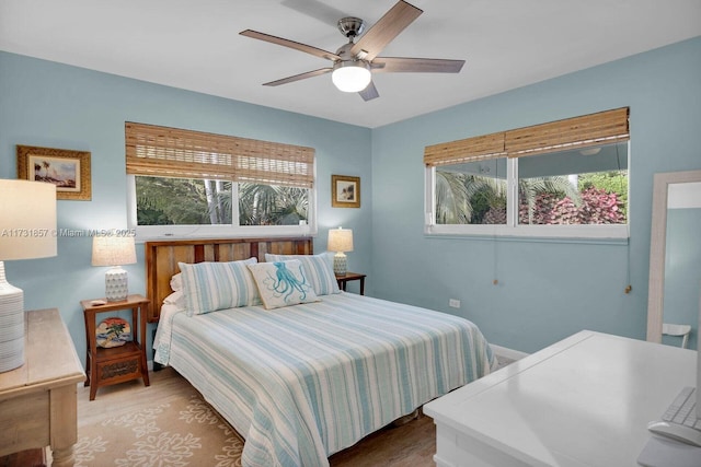 bedroom with hardwood / wood-style flooring and ceiling fan