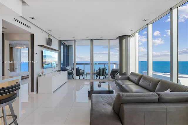 living room featuring light tile patterned flooring and floor to ceiling windows