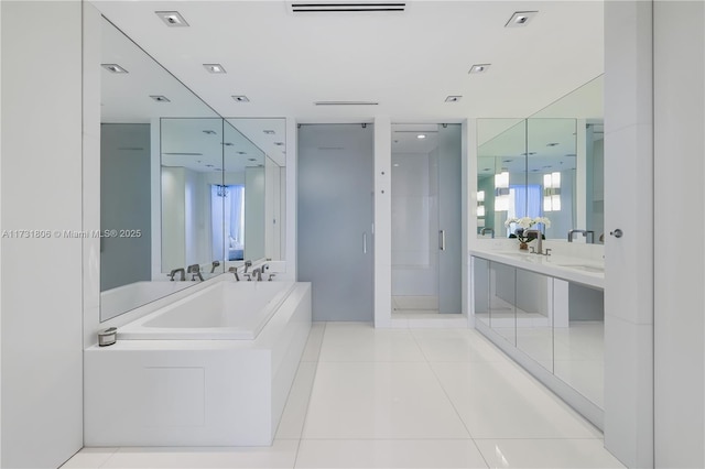 bathroom featuring tile patterned floors, separate shower and tub, and vanity