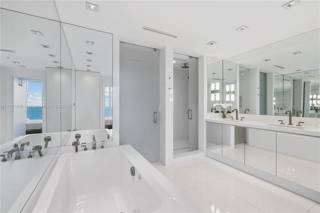 bathroom with independent shower and bath, vanity, a water view, and tile patterned flooring