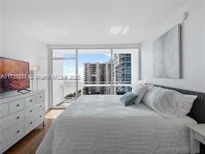 bedroom featuring floor to ceiling windows and hardwood / wood-style floors