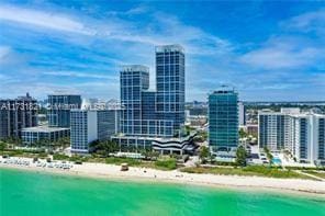 exterior space featuring a water view and a beach view