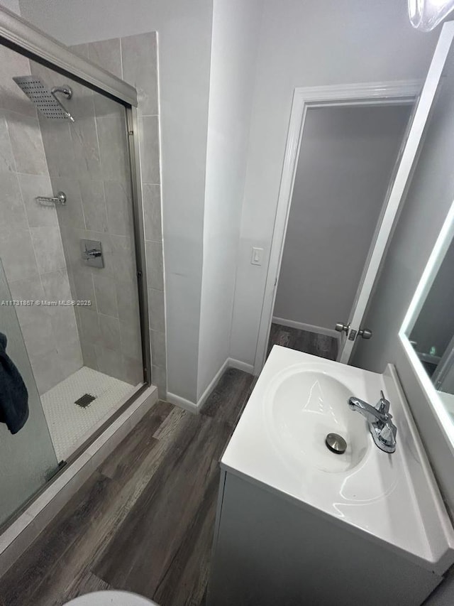 bathroom with vanity, hardwood / wood-style floors, and walk in shower