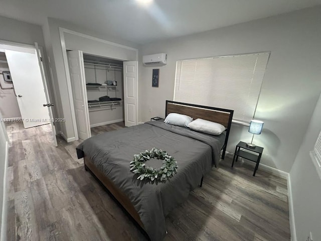 bedroom with wood-type flooring and an AC wall unit