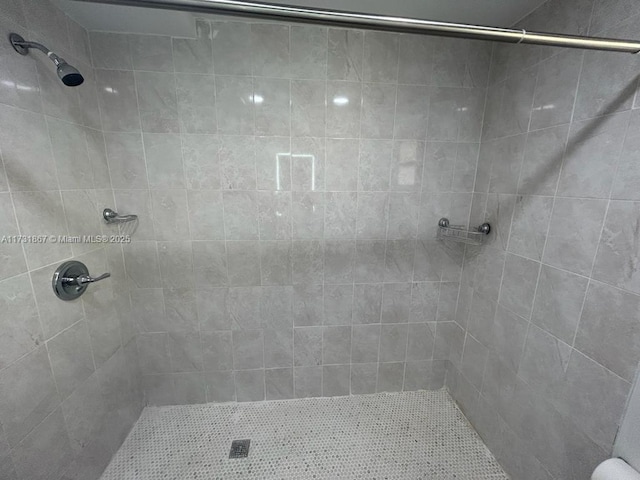 bathroom with tiled shower