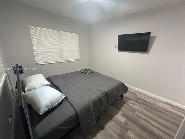 bedroom with hardwood / wood-style flooring