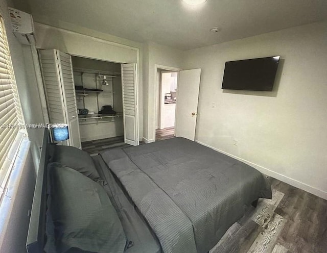 bedroom with dark wood-type flooring and a closet