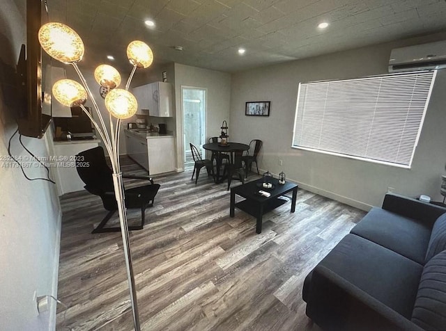 living room featuring a wall mounted air conditioner and wood-type flooring