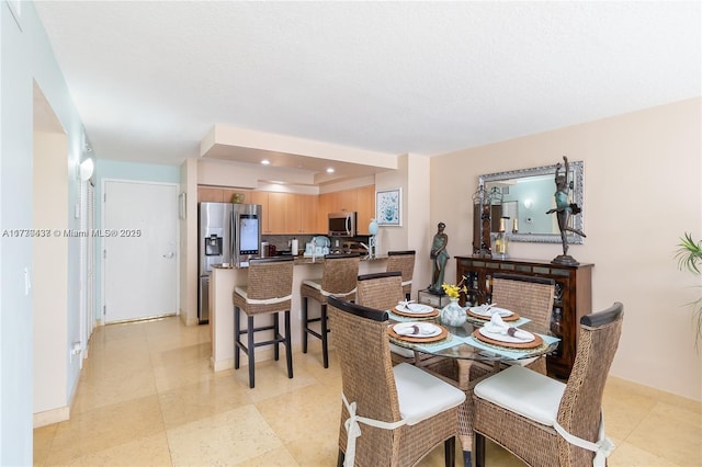 dining room with a raised ceiling