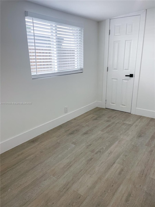 spare room with hardwood / wood-style flooring