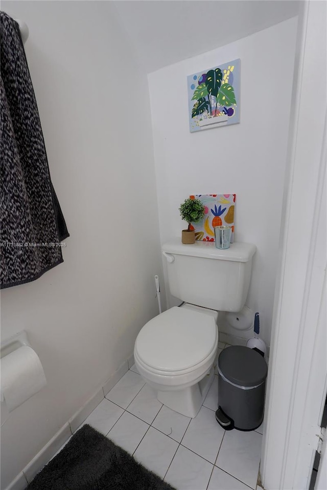 bathroom with tile patterned flooring and toilet