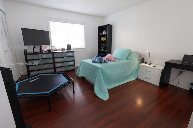 bedroom featuring dark hardwood / wood-style floors and a closet