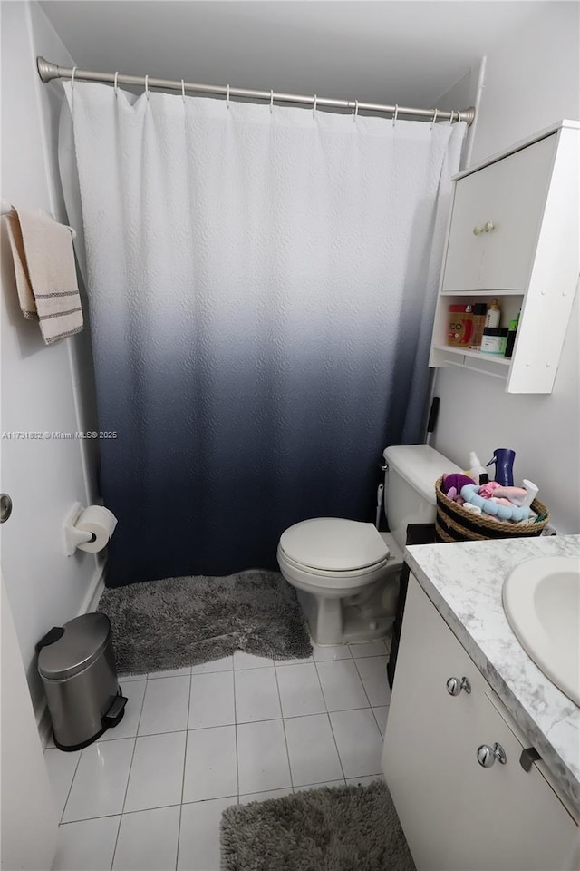 bathroom featuring tile patterned floors, toilet, and vanity