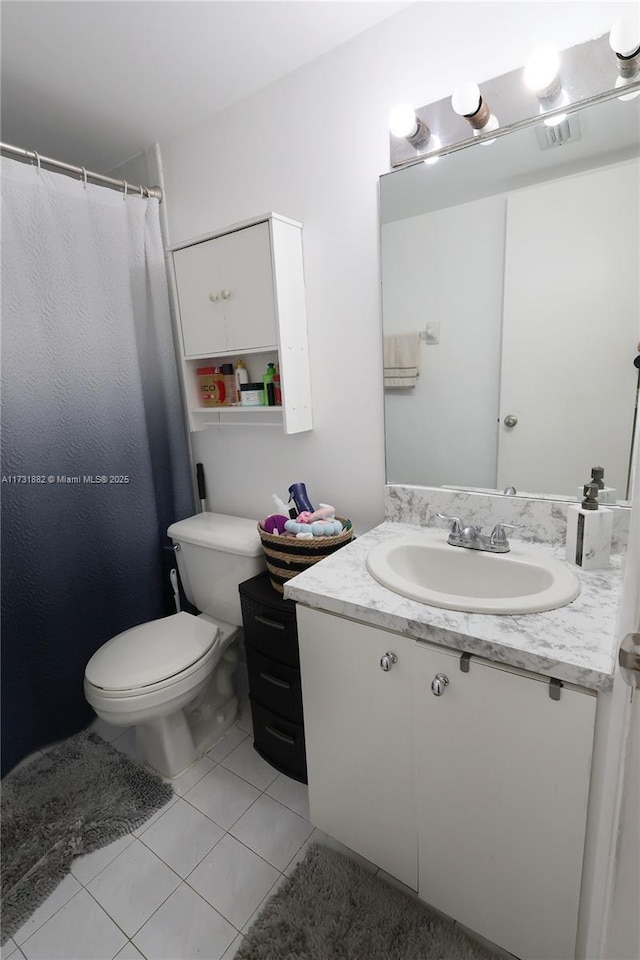 bathroom featuring tile patterned floors, toilet, and vanity